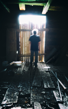 man from behind in abandoned cabin